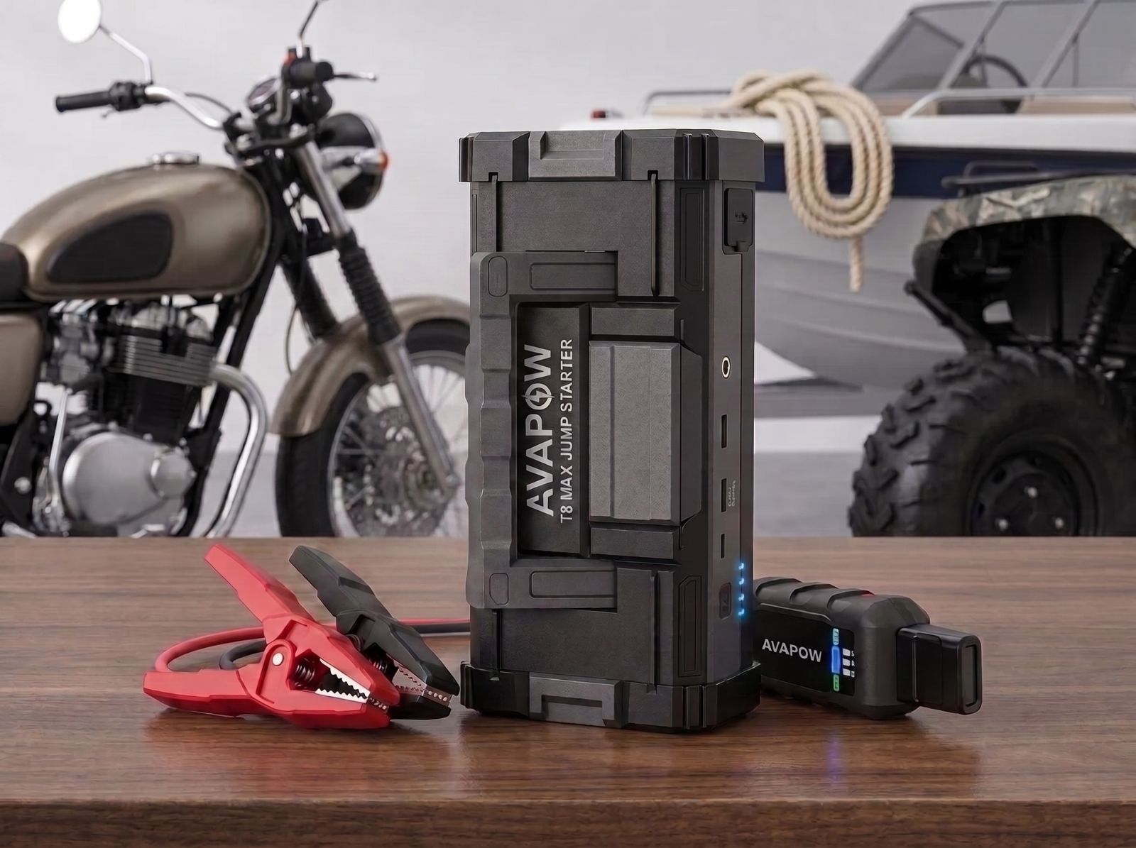 AVAPOW T8 Max portable jump starter with smart jumper clamps displayed in a garage, suitable for cars, motorcycles, boats, and ATVs.