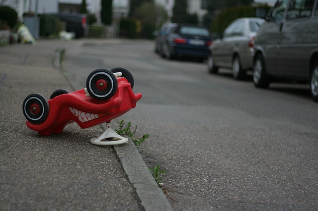 Upside down red toy car