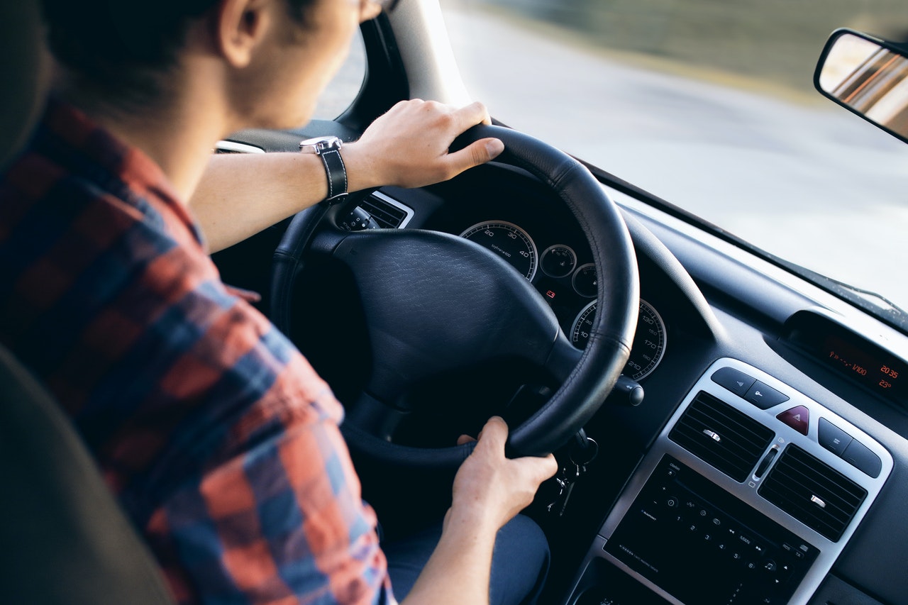 driver with both hands on the wheel