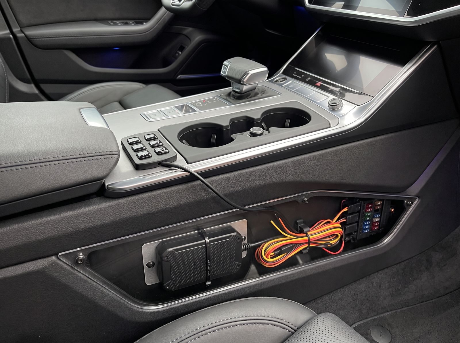 Engine keypad immobiliser control module securely installed inside a vehicle centre console with concealed wiring for enhanced anti-theft protection.