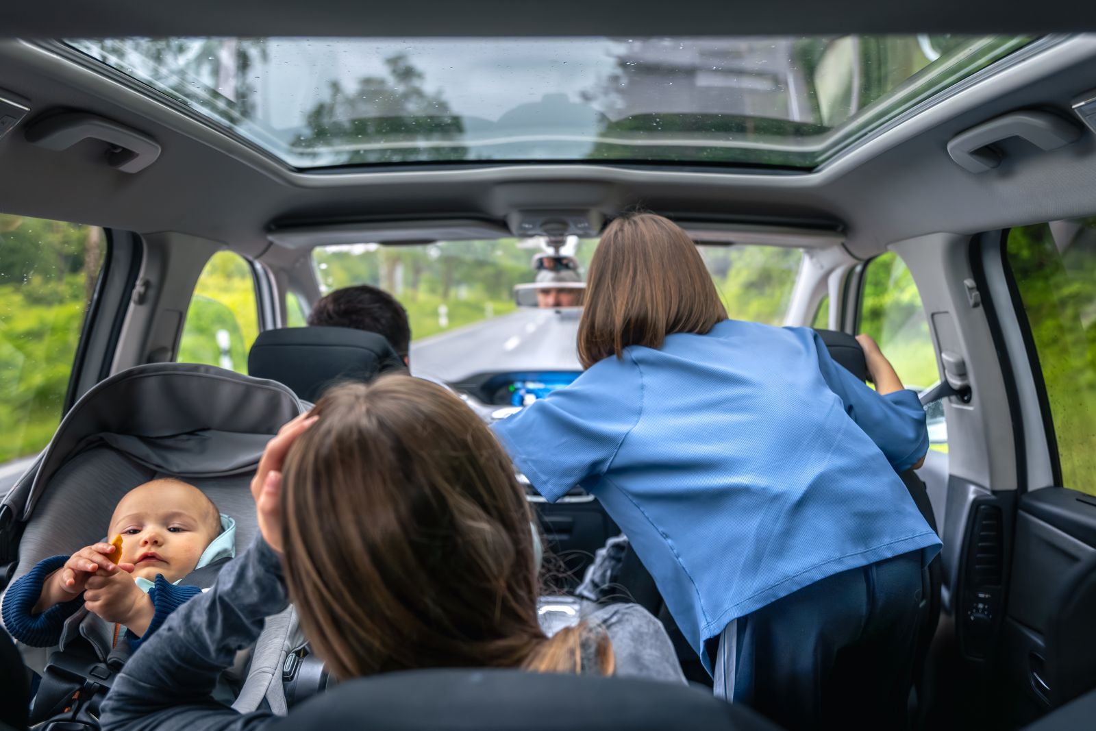 kids inside a car watching something in front