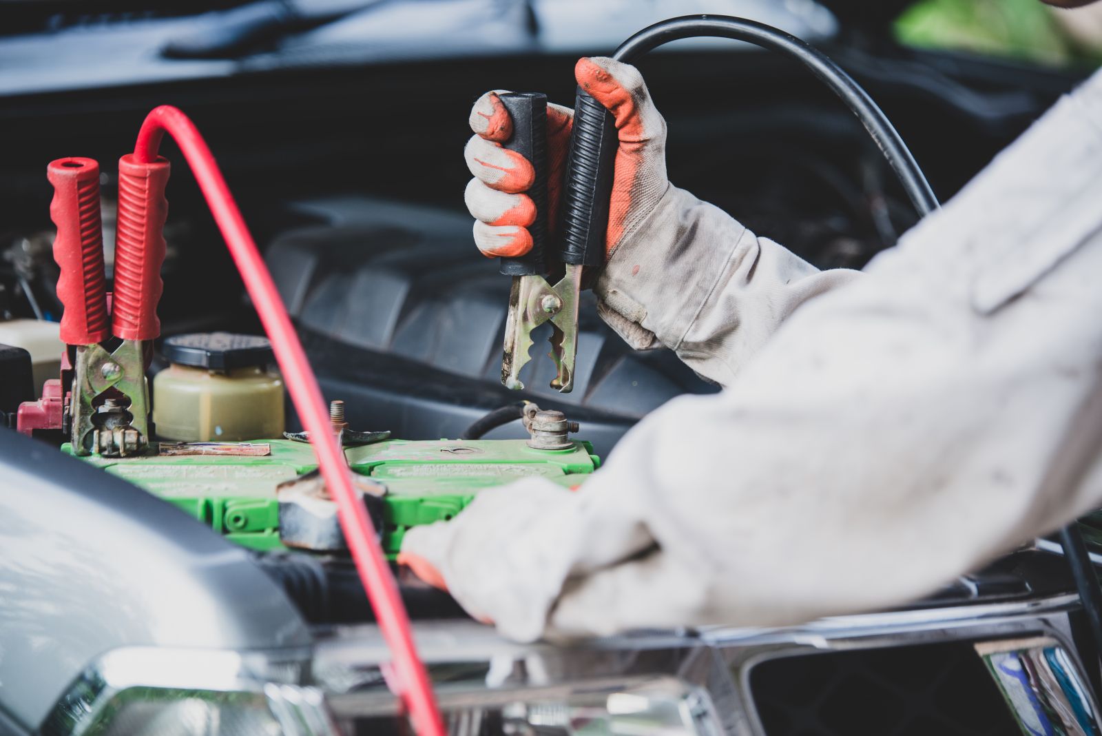 man-using-a-car-jump-starter