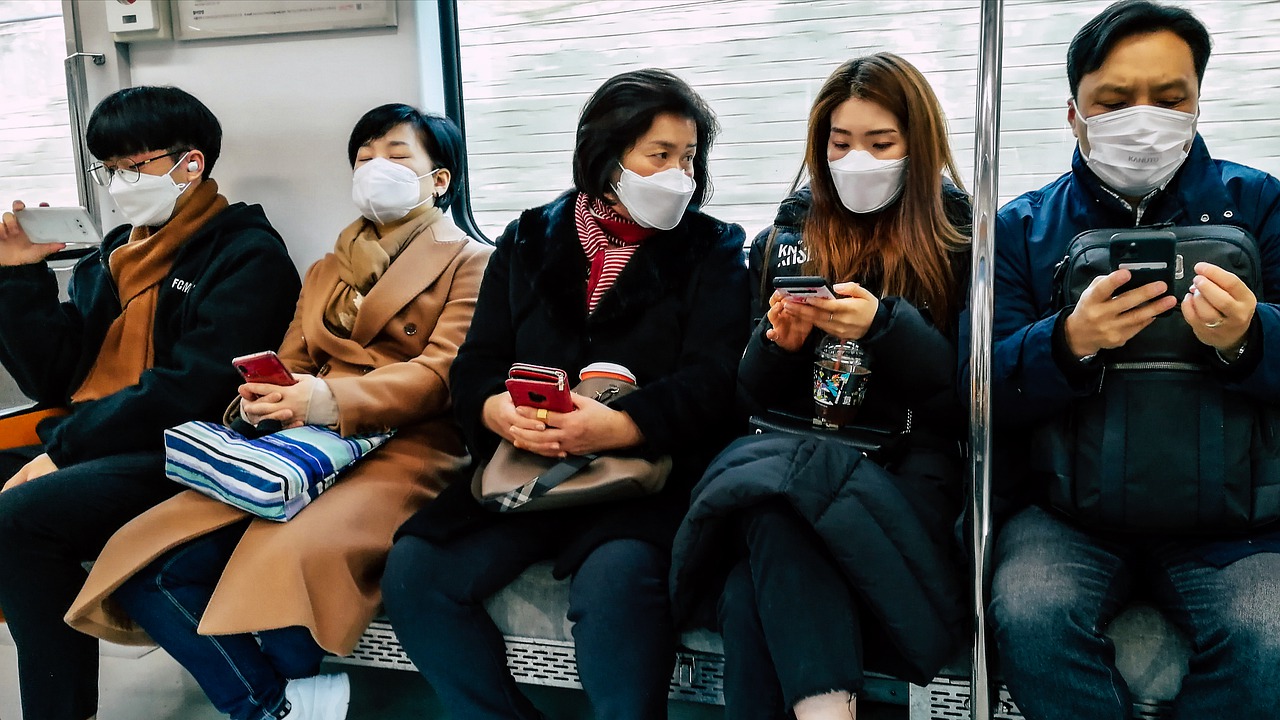 people in train wearing masks